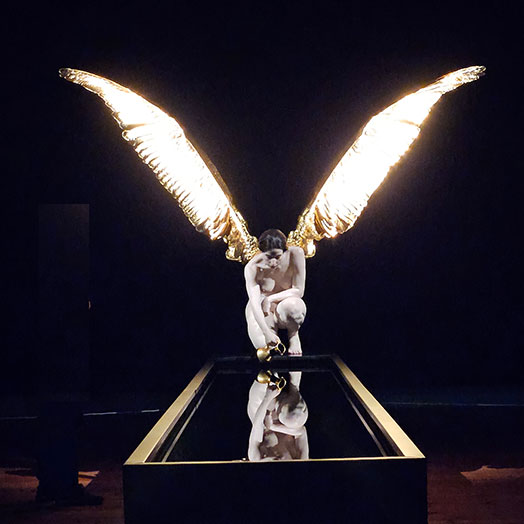 A photo I took of 'The Messenger (Iris)' by Australian artist Sam Jinks. It's of a life-size angel looking into a reflecting pool. We saw it at the Queen Victoria Museum & Art Gallery in Tasmania.